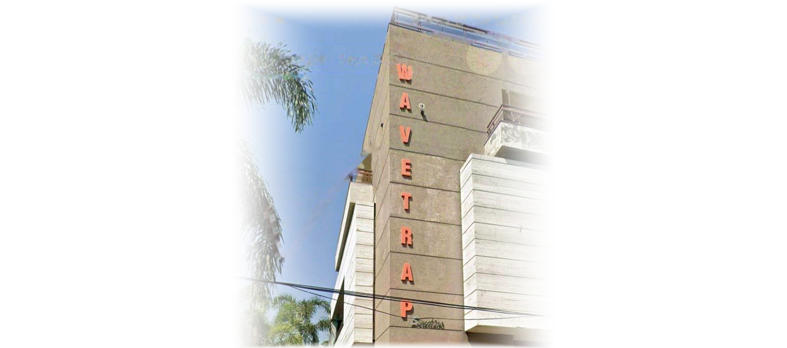 Wavetrap Studios' building in Ludhiana, the vertical WAVETRAP signage on its corner, fading into the page at the edges